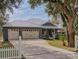 Home with three-car garage and white picket fence at 1004 Flying M Ct, Edgewater, FL 32132