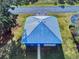 Blue metal roof garage with white door and walkway at 1004 Flying M Ct, Edgewater, FL 32132