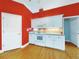 Bright eat-in kitchen with white cabinets, granite countertops, and red walls at 1004 Flying M Ct, Edgewater, FL 32132