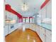 Kitchen with white cabinets, granite counters, and red walls at 1004 Flying M Ct, Edgewater, FL 32132