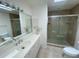 Bathroom boasts a large vanity, walk-in shower, and updated fixtures at 1104 Red Maple Way, New Smyrna Beach, FL 32168