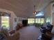 Spacious living room with vaulted ceilings and golf course view at 1104 Red Maple Way, New Smyrna Beach, FL 32168