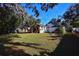 Large backyard with mature trees and green grass at 1116 Magnolia St, New Smyrna Beach, FL 32168