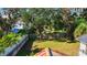 Large backyard with mature trees and a wooden fence at 1116 Magnolia St, New Smyrna Beach, FL 32168