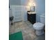 Clean bathroom with a vanity, toilet, and tiled floors at 1116 Magnolia St, New Smyrna Beach, FL 32168