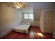 Simple bedroom with hardwood floors and a ceiling fan at 1116 Magnolia St, New Smyrna Beach, FL 32168