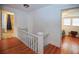 Upstairs hallway with hardwood floors, showing access to bedrooms and bathroom at 1116 Magnolia St, New Smyrna Beach, FL 32168