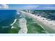 Aerial view of the ocean, shoreline and buildings at 113 Lagoon Ct, New Smyrna Beach, FL 32169
