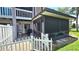 Enclosed backyard area with white picket fence, screened-in porch and patio at 113 Lagoon Ct, New Smyrna Beach, FL 32169