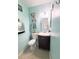 Stylish bathroom features a modern vanity, elegant mirror, and calming blue walls at 113 Lagoon Ct, New Smyrna Beach, FL 32169