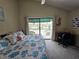 Bright bedroom with a king-size bed, private balcony, and ocean view at 113 Lagoon Ct, New Smyrna Beach, FL 32169