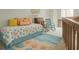 Bright bedroom featuring beach-themed decor, including a rug with ocean waves and sea stars at 113 Lagoon Ct, New Smyrna Beach, FL 32169