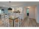 Dining room with a glass table, seating for six, and modern light fixture at 113 Lagoon Ct, New Smyrna Beach, FL 32169