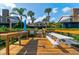Wooden dock with picnic tables and a cleaning station offers a scenic space for relaxation and community gatherings at 113 Lagoon Ct, New Smyrna Beach, FL 32169