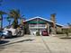 Two-story brick home with balconies, double garage, and palm trees at 113 Lagoon Ct, New Smyrna Beach, FL 32169