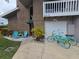 Charming condo with brick facade, balcony, garage, and two beach cruisers parked out front at 113 Lagoon Ct, New Smyrna Beach, FL 32169