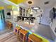 Bright kitchen with seating at the bar, modern countertops, and white cabinetry at 113 Lagoon Ct, New Smyrna Beach, FL 32169