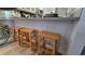 Kitchen counter with wooden stools, neutral countertop, and stainless steel faucet at 113 Lagoon Ct, New Smyrna Beach, FL 32169