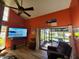 Living room with patio access and large TV at 113 Lagoon Ct, New Smyrna Beach, FL 32169