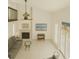 Sun-filled living room with a fireplace, vaulted ceiling, and large windows at 113 Lagoon Ct, New Smyrna Beach, FL 32169