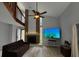 Inviting living room with a brick fireplace, a ceiling fan, and lots of natural light at 113 Lagoon Ct, New Smyrna Beach, FL 32169