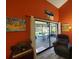 Living room with sliding glass doors opening to a patio at 113 Lagoon Ct, New Smyrna Beach, FL 32169