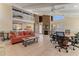 Inviting living room featuring a cozy fireplace, high ceilings, and bright, natural light at 113 Lagoon Ct, New Smyrna Beach, FL 32169