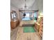 Bedroom with four-poster bed, light wood floors, and lots of natural light at 113 Lagoon Ct, New Smyrna Beach, FL 32169