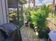 Private patio with potted plants and a covered grill at 113 Lagoon Ct, New Smyrna Beach, FL 32169