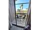 View of the pool area with palm trees from the balcony with seating at 113 Lagoon Ct, New Smyrna Beach, FL 32169