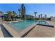 Community pool with lounge chairs and palm trees at 113 Lagoon Ct, New Smyrna Beach, FL 32169