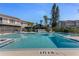 Community pool with lounge chairs and palm trees at 113 Lagoon Ct, New Smyrna Beach, FL 32169