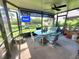 Relaxing screened patio with table and chairs, overlooking pool at 113 Lagoon Ct, New Smyrna Beach, FL 32169