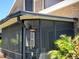 Covered patio with hanging wind chimes, offering a peaceful outdoor space at 113 Lagoon Ct, New Smyrna Beach, FL 32169