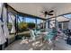 Inviting screened porch featuring comfortable seating, ceiling fan, and a pleasant outdoor view at 113 Lagoon Ct, New Smyrna Beach, FL 32169