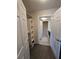 Walk-in closet leading to a bathroom with a shower featuring wood-look vinyl flooring at 113 Lagoon Ct, New Smyrna Beach, FL 32169