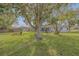 Expansive backyard with large tree and seating area at 1339 N Fowler Dr, Deltona, FL 32725