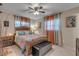 Bedroom with wood bed frame, orange curtains, and ceiling fan at 1339 N Fowler Dr, Deltona, FL 32725