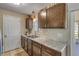 Kitchen with wood cabinets, granite counters, and window view at 1339 N Fowler Dr, Deltona, FL 32725