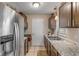 Galley kitchen with stainless steel appliances and granite counters at 1339 N Fowler Dr, Deltona, FL 32725