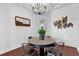 Charming dining area with a round table, four chairs, and stylish wall art at 1409 Arbitus Cir, Oviedo, FL 32765