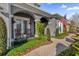 Relaxing front porch with rocking chairs, brick walkway, and beautiful landscaping at 1409 Arbitus Cir, Oviedo, FL 32765