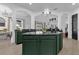 Kitchen with dark green island, granite countertops, and stainless steel appliances at 1409 Arbitus Cir, Oviedo, FL 32765