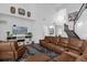 Living room with sectional sofa, hardwood floors, and a large TV at 1409 Arbitus Cir, Oviedo, FL 32765