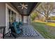 Relaxing patio overlooking a pond, with seating and a ceiling fan at 1409 Arbitus Cir, Oviedo, FL 32765