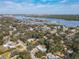 Wide aerial shot of the neighborhood, with many trees and a river in the distance at 1423 Palmetto St, New Smyrna Beach, FL 32168