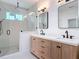 Bathroom featuring dual sinks with modern fixtures, a large mirror, glass shower and recessed lighting at 1423 Palmetto St, New Smyrna Beach, FL 32168