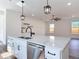 Bright kitchen with large island featuring a sink and stainless steel dishwasher at 1423 Palmetto St, New Smyrna Beach, FL 32168