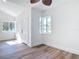 Bright living room features wood floors, natural light from the windows, and fresh white paint at 1423 Palmetto St, New Smyrna Beach, FL 32168