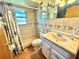 Bathroom with tiled shower, vanity, and nautical decor at 1424 Breaks Way, Port Orange, FL 32127